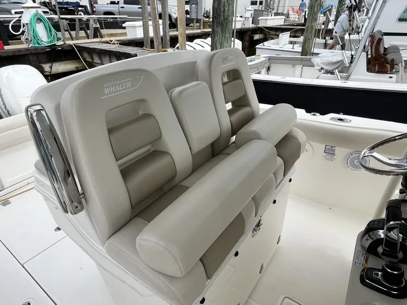 Slide: The Image of 2018 Boston Whaler 330 Outrage boat seating area with luxurious beige upholstery. - 18