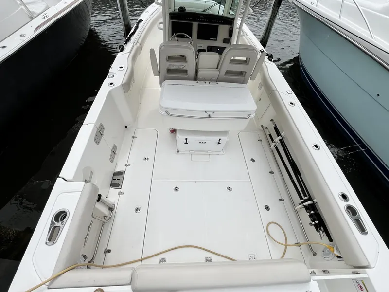 Slide: The Image of 2018 Boston Whaler 330 Outrage boat interior, featuring spacious deck and seating. - 14