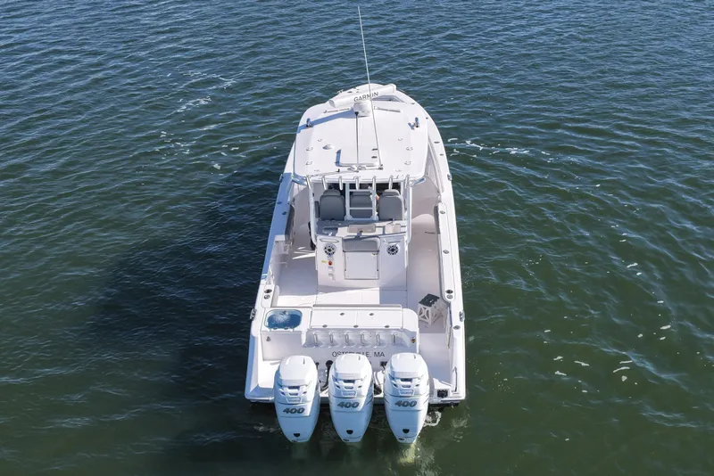 Slide: The Image of 2022 Everglades 365 Center Console boat with triple 400 horsepower engines on open water. - 15