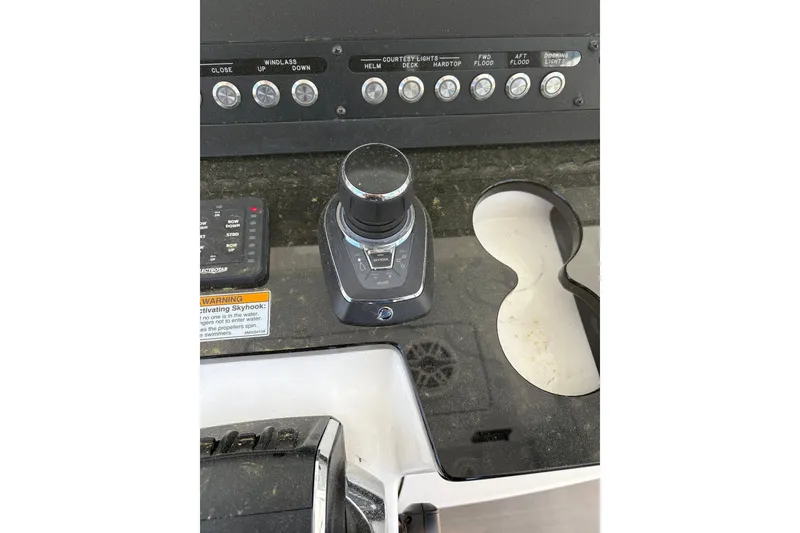 Slide: The Image of Control panel of 2022 Everglades 365 Center Console boat with joystick and switches. - 22