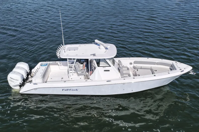 Slide: The Image of 2022 Everglades 365 Center Console boat on water, featuring sleek design and twin Mercury engines. - 14
