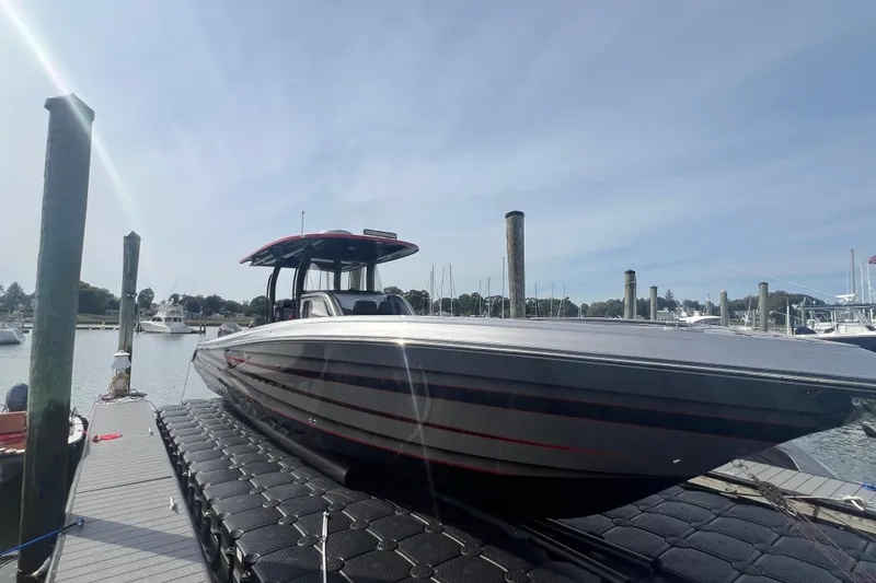 The Image of 2021 Fountain 39 NX boat docked at a marina under a clear sky. - 1