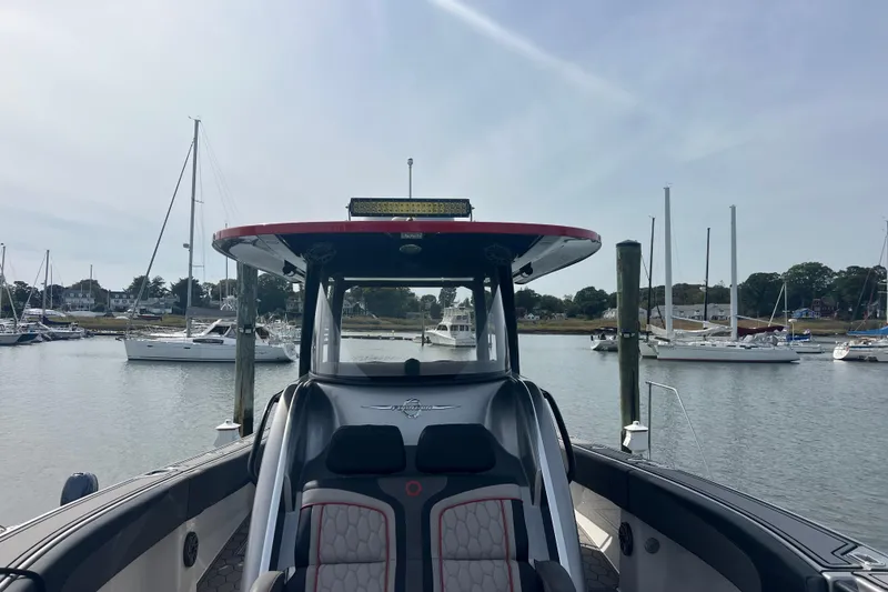 Slide: The Image of 2021 Fountain 39 NX boat docked in a marina with sailboats in the background. - 17