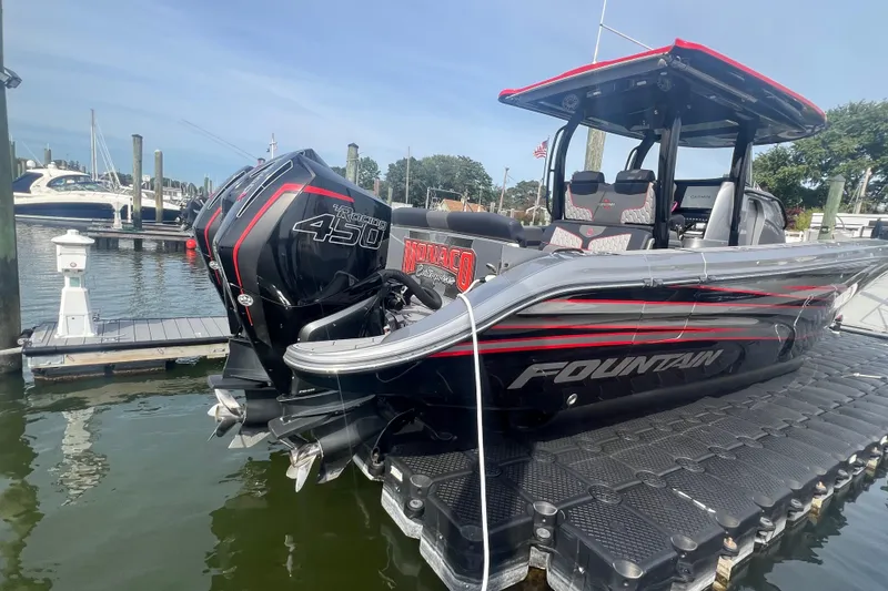 Slide: The Image of 2021 Fountain 39 NX boat docked, featuring powerful Mercury Racing 450 engines. - 6