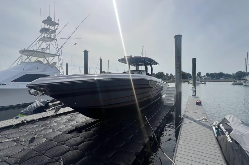 Slide: The Image of 2021 Fountain 39 NX boat docked at marina under bright sunlight. - 5