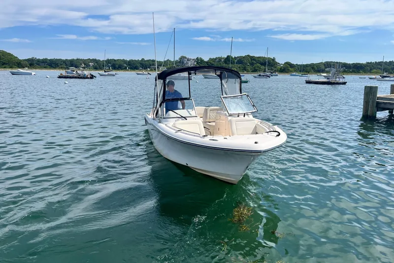 Slide: The Image of 2021 Grady-White Freedom 215 boat cruising on a scenic lake. - 5