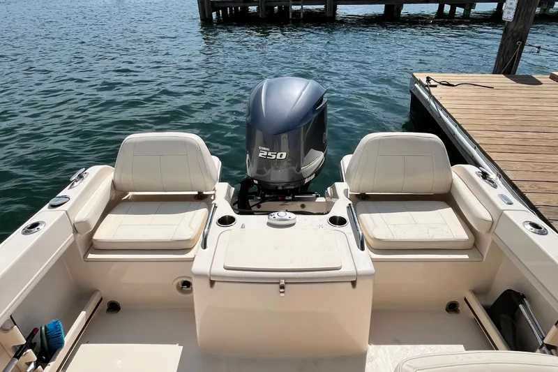 Slide: The Image of 2021 Grady-White Freedom 215 boat with Yamaha 250 engine, docked by the water. - 10