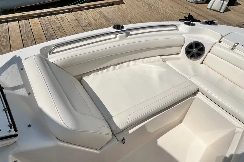 Slide: The Image of 2021 Grady-White Freedom 215 boat interior with white cushioned seating and speaker. - 26