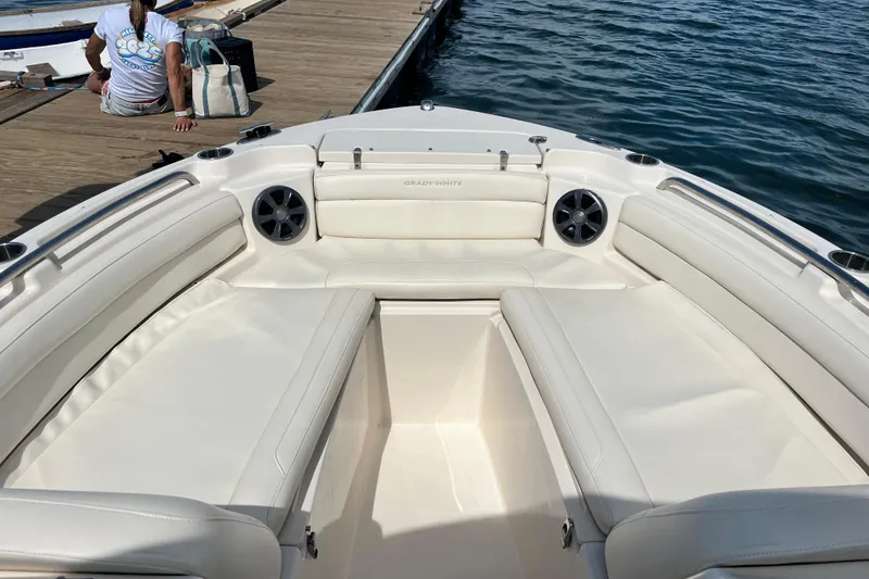 Slide: The Image of 2021 Grady-White Freedom 215 boat interior with white seating, docked by the water. - 25