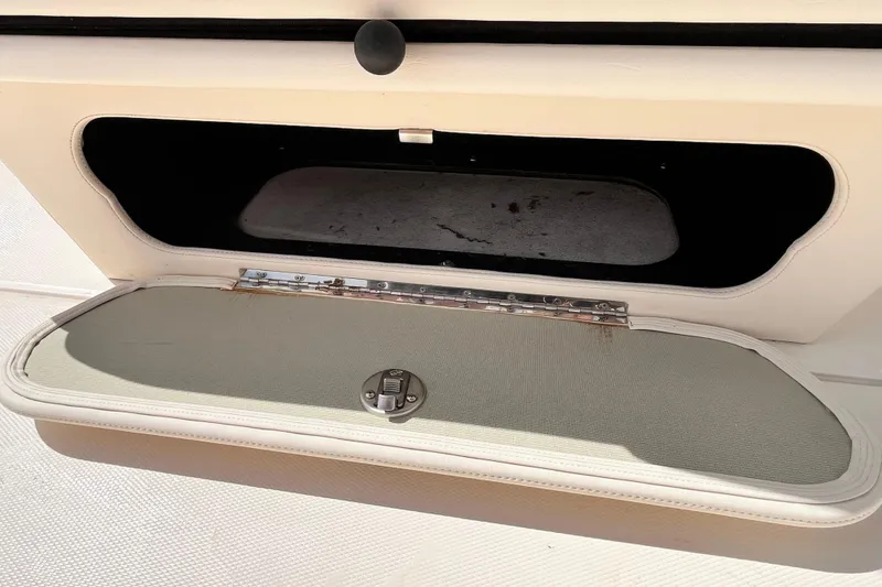 Slide: The Image of Open storage compartment on a 2021 Grady-White Freedom 215 boat. - 32