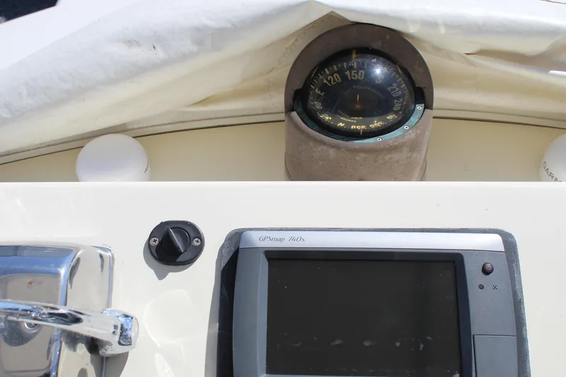 Slide: The Image of 1985 Viking Express boat dashboard with compass and navigation display. - 11