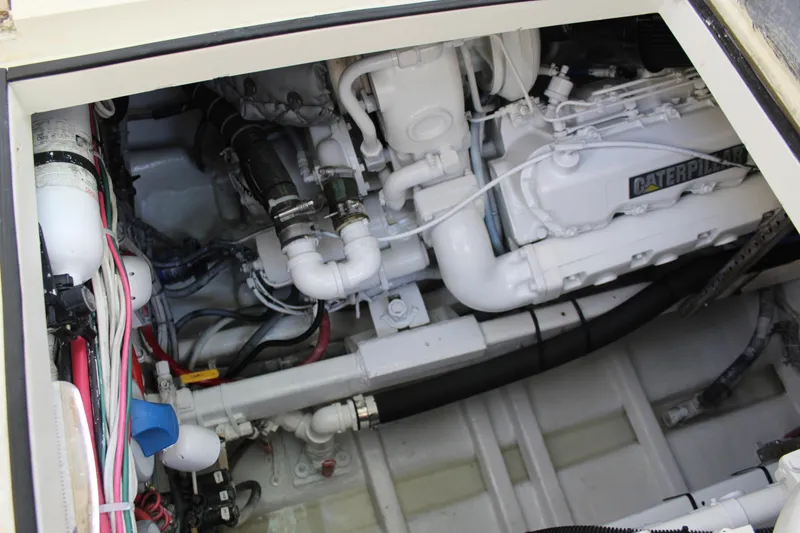 Slide: The Image of Engine compartment of 1985 Viking Express boat, featuring Caterpillar engine components. - 21