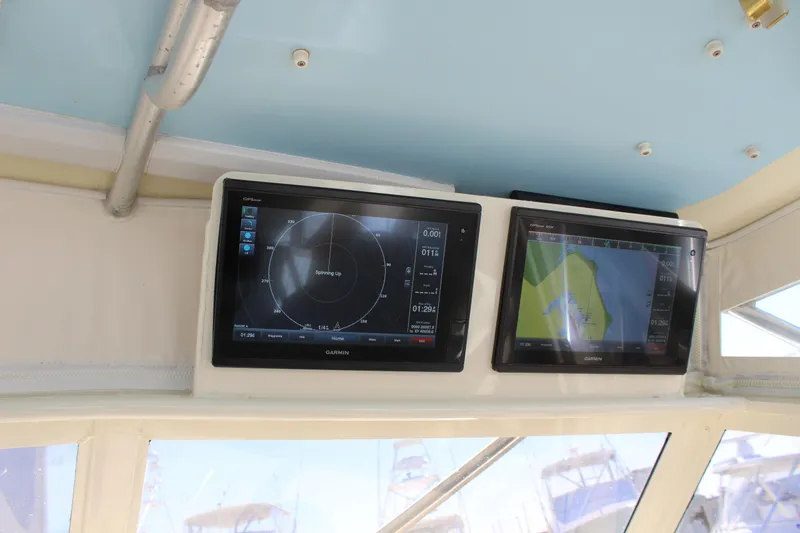 Slide: The Image of 1985 Viking Express boat navigation screens displaying radar and map. - 19