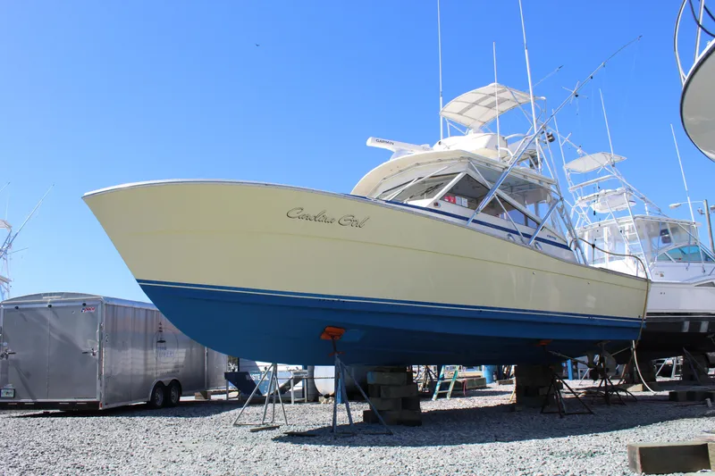 Slide: The Image of 1985 Viking Express boat on dry dock, yellow and blue hull, clear sky background. - 4