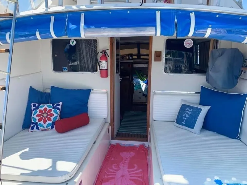 Slide: The Image of 1980 Bertram 33 Sport Fisherman boat interior with blue and white cushions. - 17