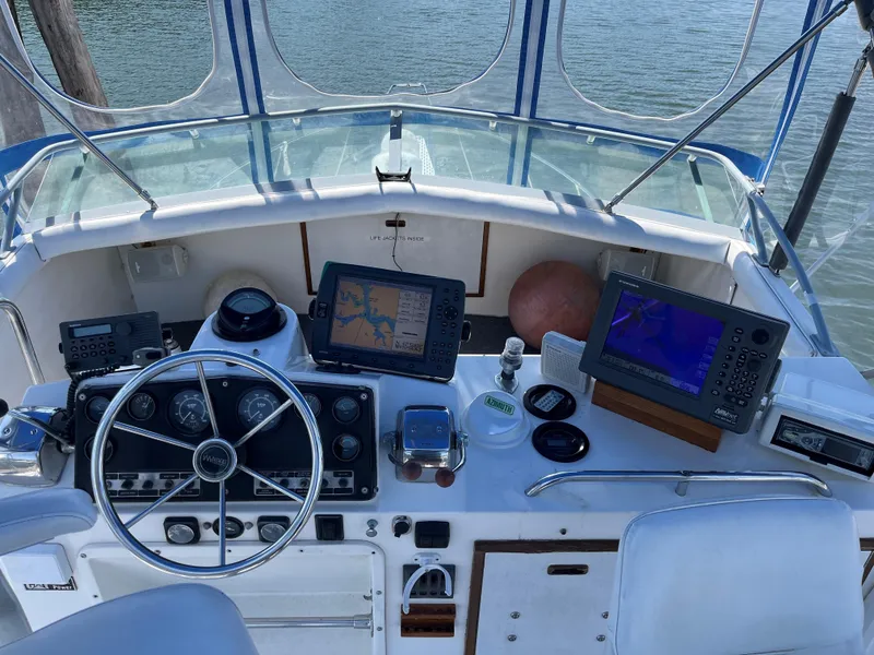 Slide: The Image of 1980 Bertram 33 Sport Fisherman cockpit with navigation equipment and steering wheel. - 2