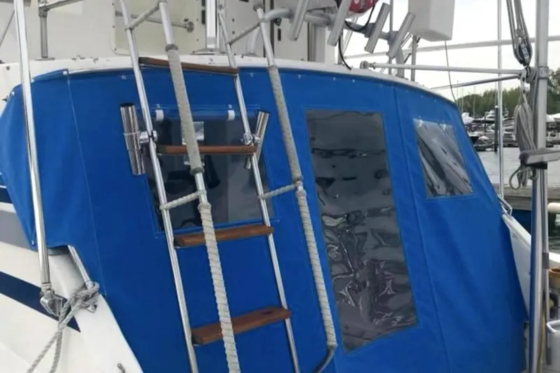 Slide: The Image of 1980 Bertram 33 Sport Fisherman with blue canvas cover and ladder. - 5