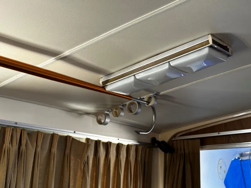 Slide: The Image of Ceiling interior of a 1980 Bertram 33 Sport Fisherman boat with rod holders and light fixture. - 10