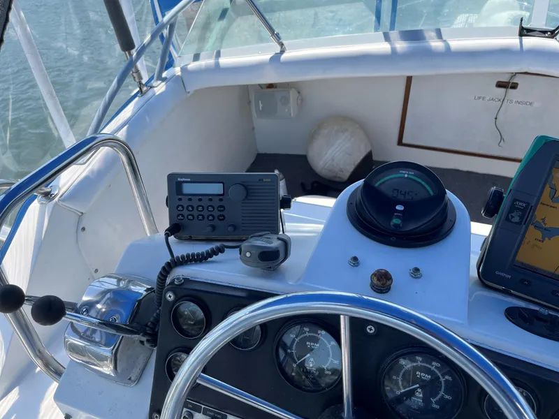 Slide: The Image of 1980 Bertram 33 Sport Fisherman boat cockpit with navigation instruments. - 8