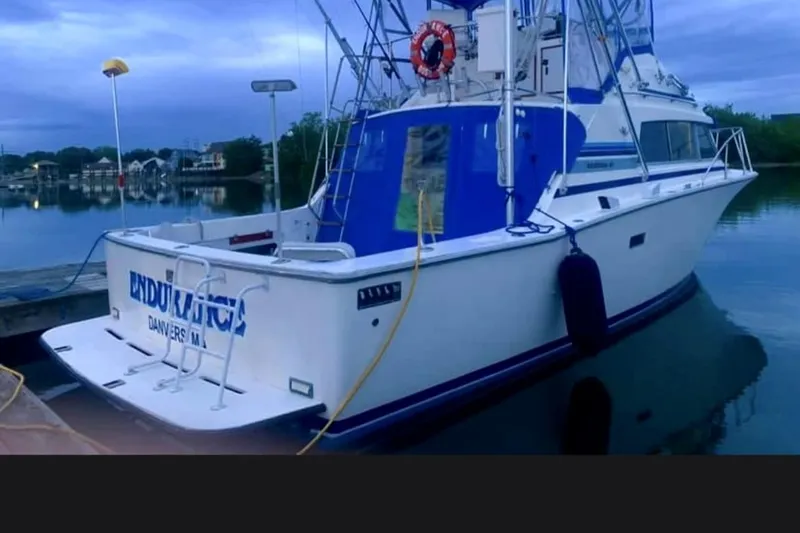 Slide: The Image of 1980 Bertram 33 Sport Fisherman docked at a marina. - 1