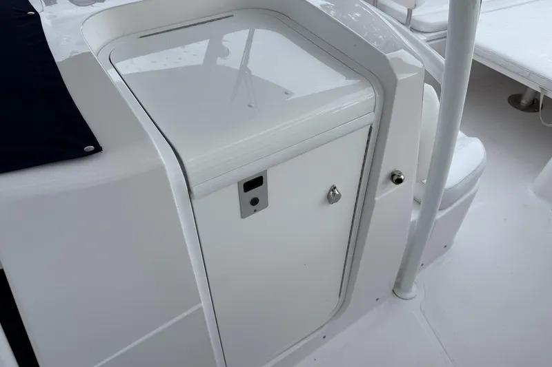 Slide: The Image of 2018 Southport 33 FE boat interior with white storage compartment and seating area. - 22