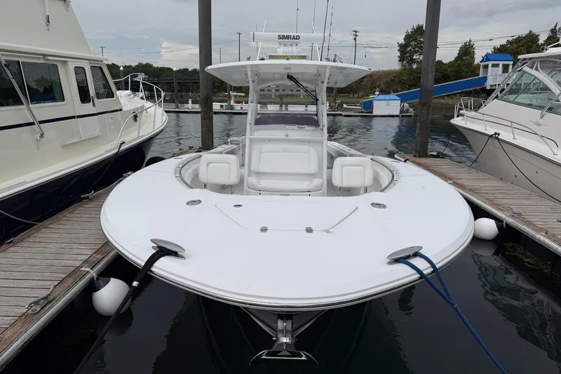 Slide: The Image of 2018 Southport 33 FE boat docked at marina, front view. - 2