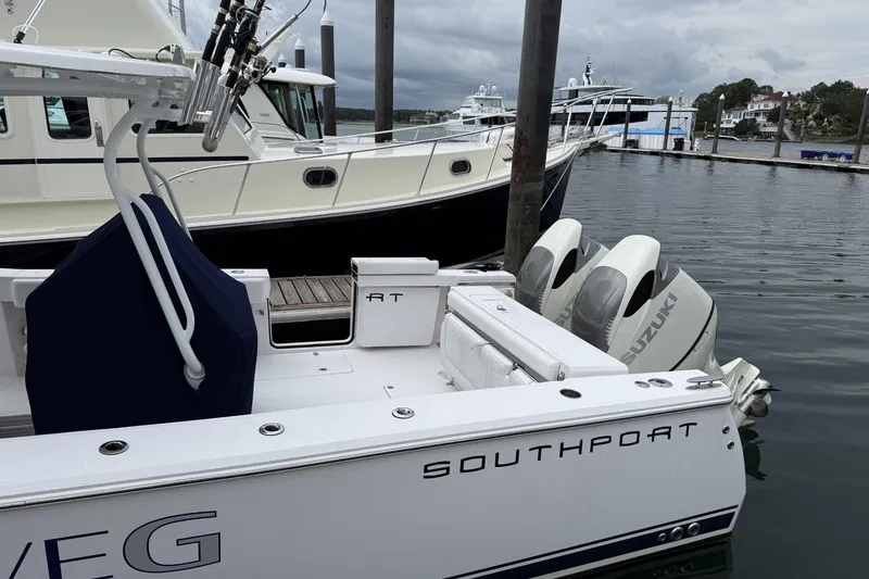Slide: The Image of 2018 Southport 33 FE boat docked with Suzuki outboard motors. - 4