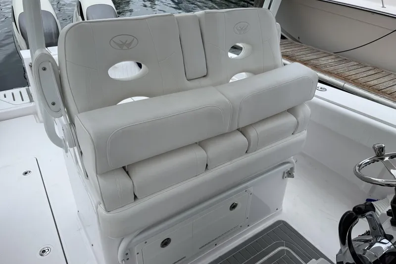Slide: The Image of Luxurious seating on 2018 Southport 33 FE boat, featuring plush white upholstery. - 14