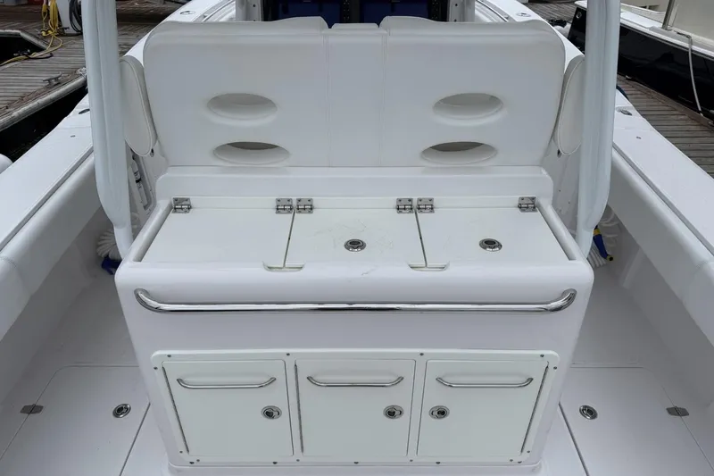Slide: The Image of 2018 Southport 33 FE boat interior with storage compartments and seating. - 12