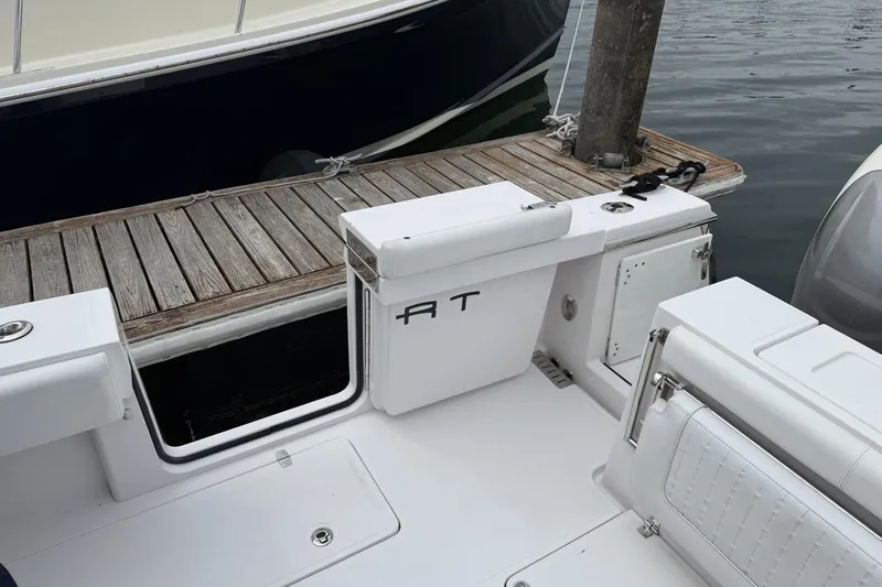Slide: The Image of 2018 Southport 33 FE boat interior with white seating and wooden dock. - 7