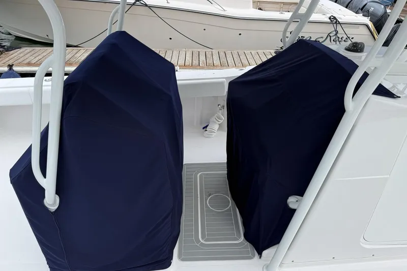 Slide: The Image of 2018 Southport 33 FE boat with covered seats, docked at a marina. - 6