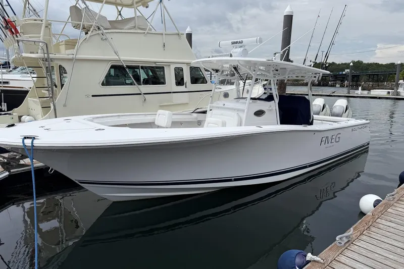 The Image of 2018 Southport 33 FE boat docked at marina, featuring sleek white design. - 1
