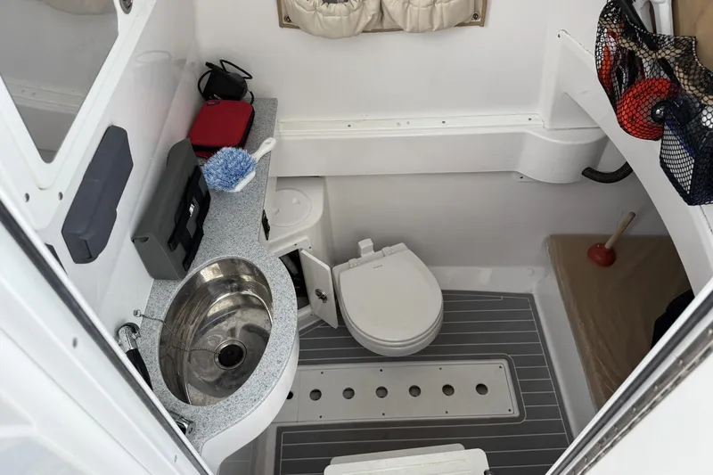 Slide: The Image of 2018 Southport 33 FE boat bathroom with sink, toilet, and storage. - 24