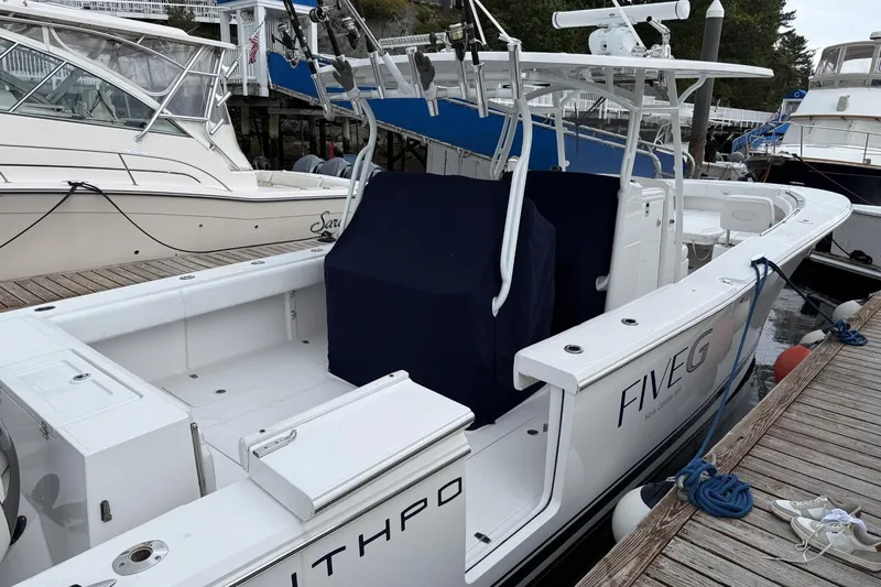 Slide: The Image of 2018 Southport 33 FE boat docked, featuring sleek design and fishing equipment. - 5