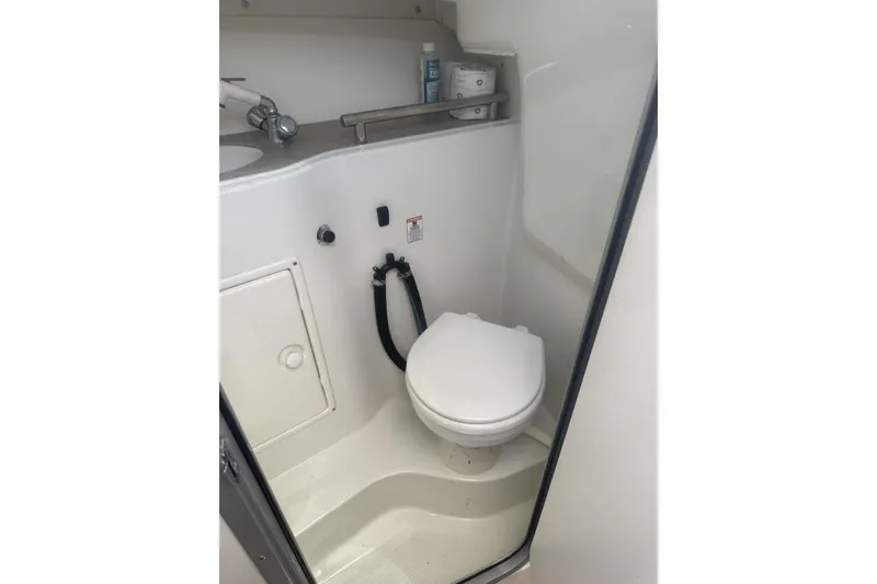 Slide: The Image of 2007 Sailfish 2660 WAC boat bathroom with toilet and sink. - 22