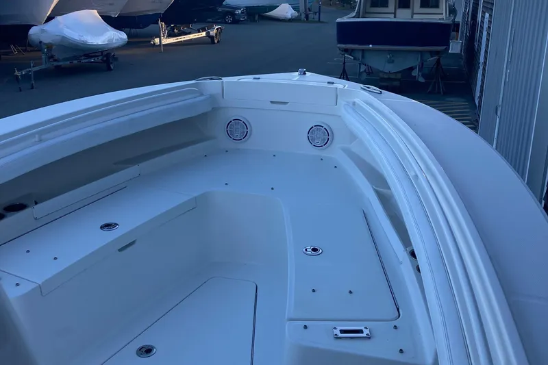 Slide: The Image of 2020 Regulator 23 Forward Seating boat, spacious deck view, docked in marina. - 18