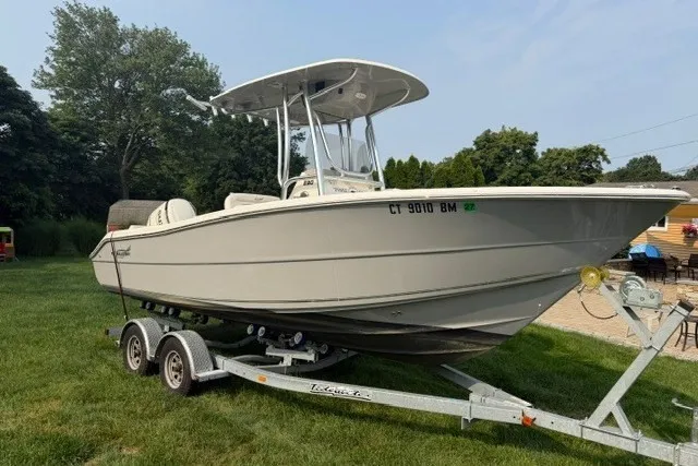 The Image of 2021 Bulls Bay 230 Center Console boat on trailer, parked on grass. - 0