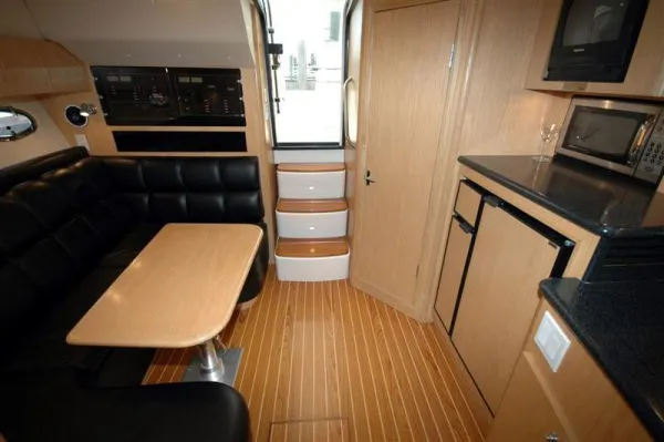 Slide: The Image of 2002 Tiara Yachts 3500 Open interior with kitchen and seating area. - 14
