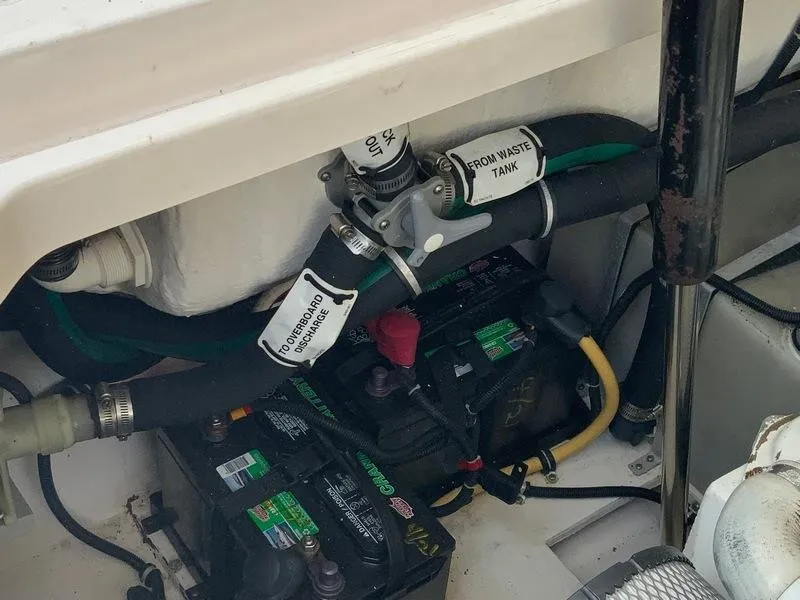 Slide: The Image of Batteries and waste tank valve in a 2002 Tiara Yachts 3500 Open. - 49