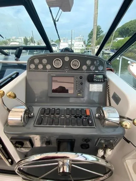Slide: The Image of 2002 Tiara Yachts 3500 Open helm with controls and gauges. - 9