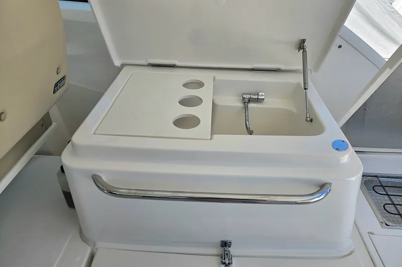 Slide: The Image of 2023 Tiara Yachts 4300 Open yacht sink with faucet and storage compartments. - 14