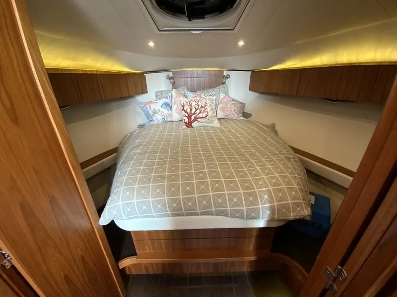 Slide: The Image of Luxurious cabin interior of 2013 Tiara Yachts 36 with cozy bedding and wood accents. - 19