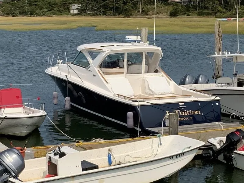 Slide: The Image of 2013 Tiara Yachts 36 docked in a serene marina setting. - 3