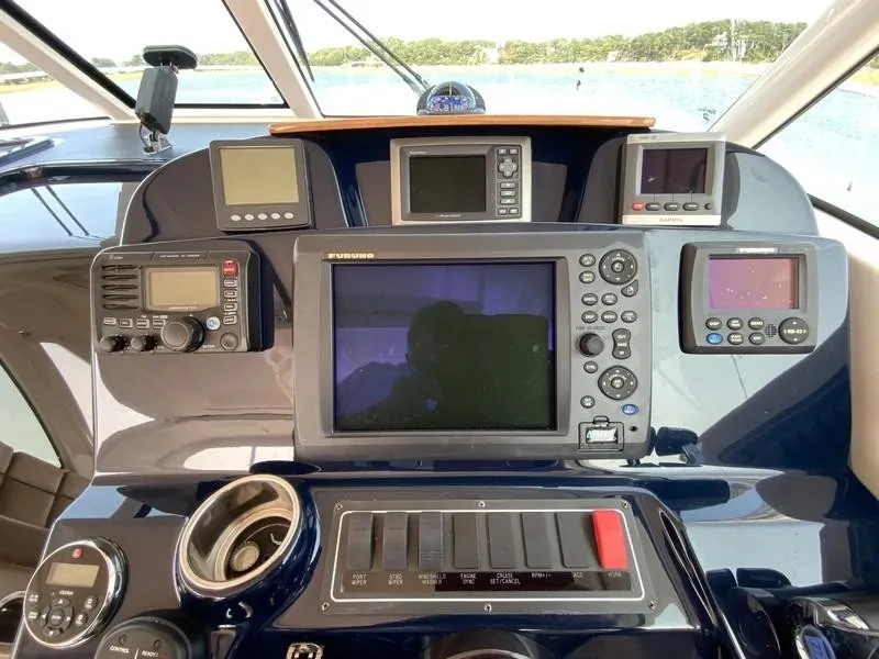 Slide: The Image of Control panel of a 2013 Tiara Yachts 36 with navigation and communication equipment. - 16