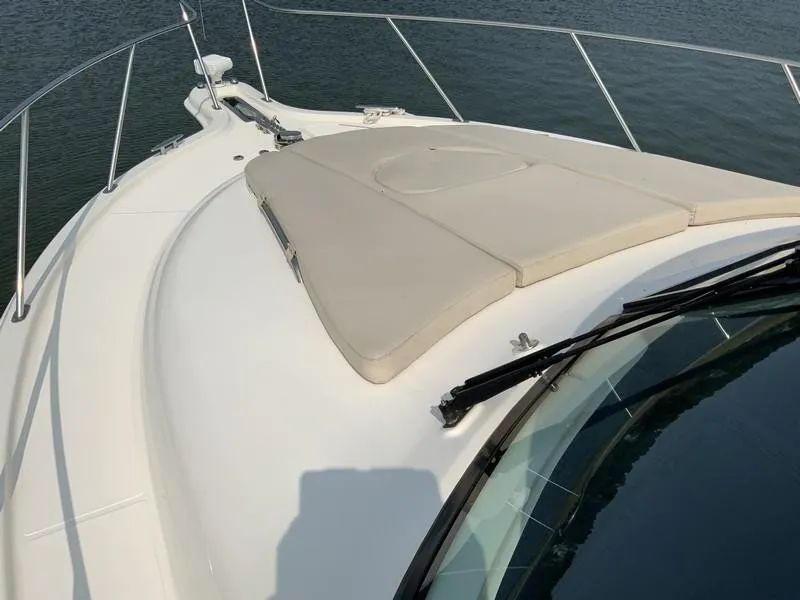 Slide: The Image of Tiara Yachts 36, 2013 model, bow view with cushioned sunpad on calm water. - 29