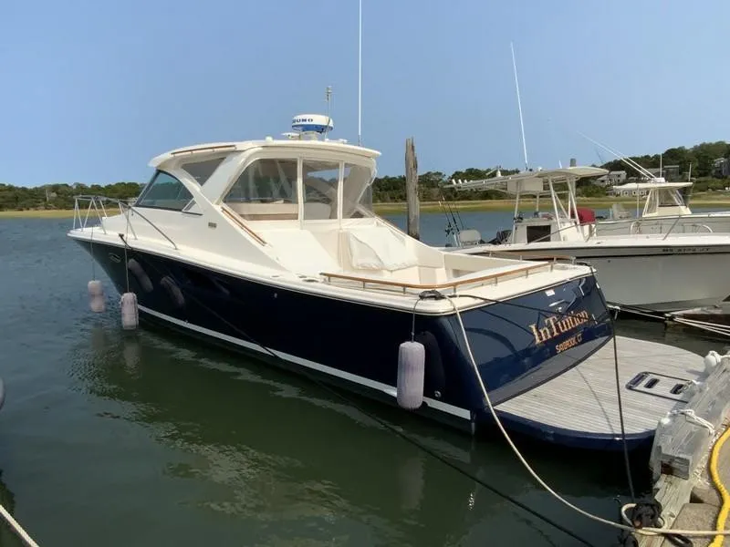 Slide: The Image of 2013 Tiara Yachts 36 docked in a serene marina setting. - 2