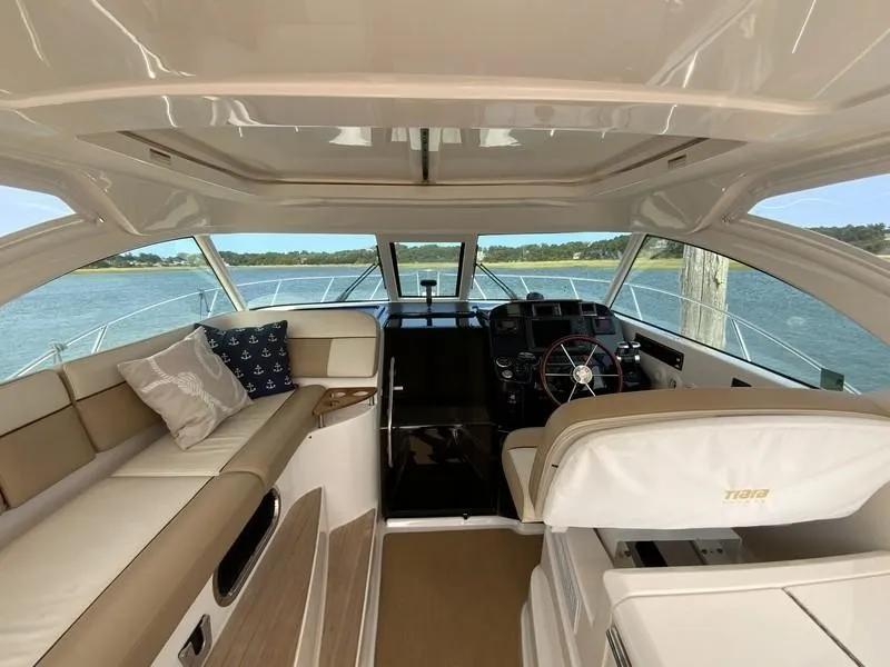 Slide: The Image of Interior of 2013 Tiara Yachts 36, featuring helm and seating area with scenic water view. - 11