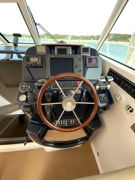 Slide: The Image of Tiara Yachts 36 helm, 2013 model, featuring advanced navigation controls and wooden steering wheel. - 17