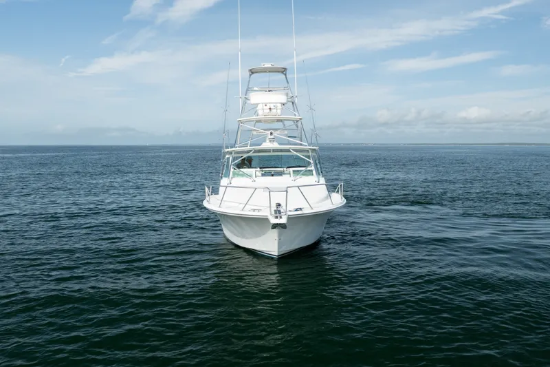Slide: The Image of 2011 Cabo 36 Express boat on open water under blue sky. - 9