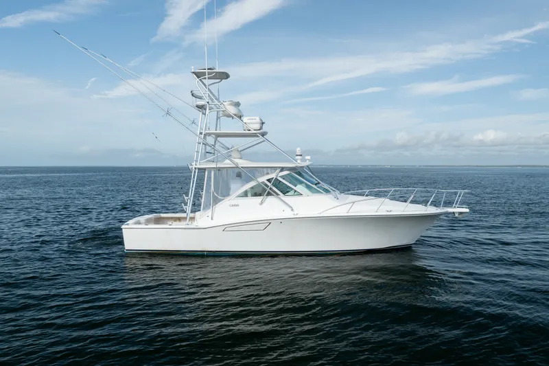 Slide: The Image of 2011 Cabo 36 Express boat on open water under a clear sky. - 12